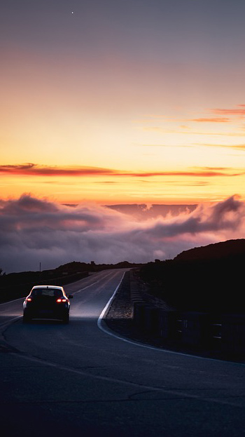 rear view of car on road at sunset