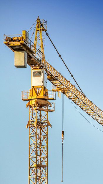 close up of yellow crane at building site